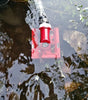 BearSpaw floating pump partially submerged in water with greenery around