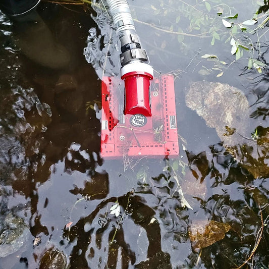 BearSpaw floating pump partially submerged in water with greenery around