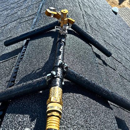 Rooftop sprinkler head mounted for exterior wildfire ember defense on residential roofs.