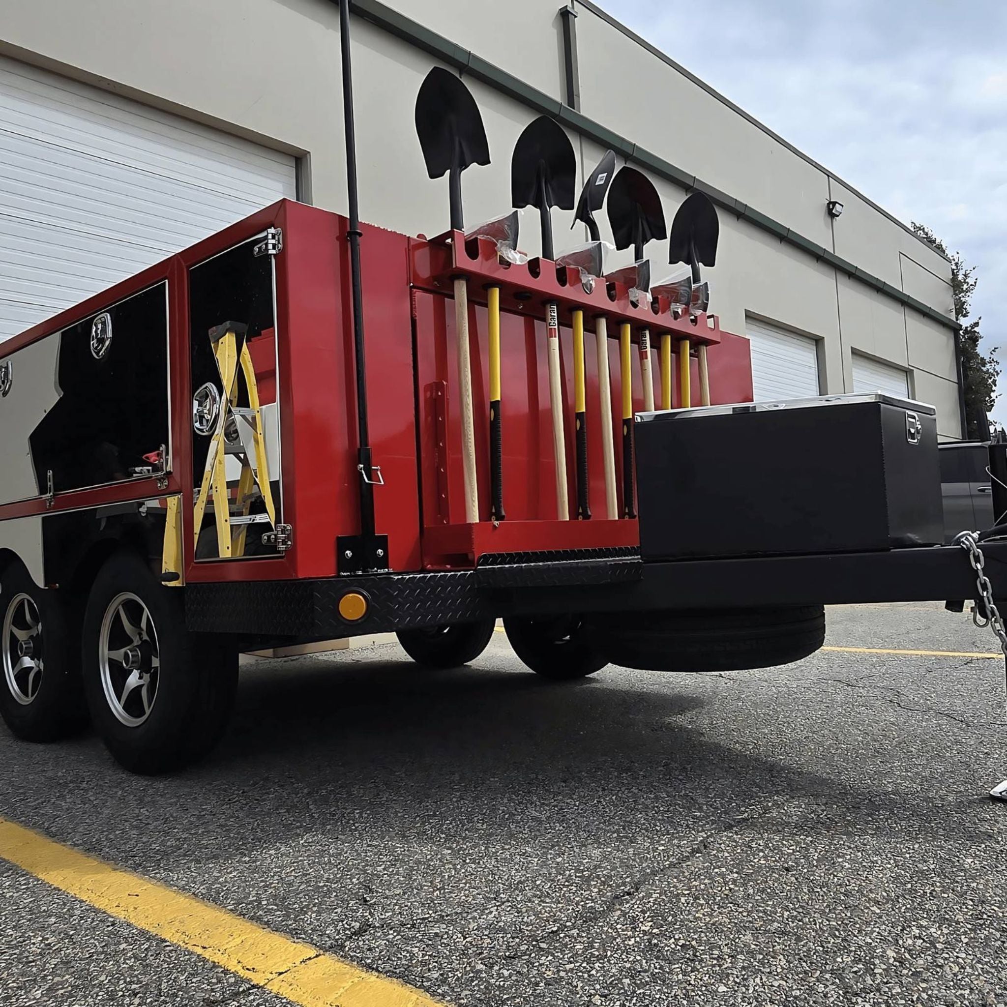 Red wildland firefighting custom apparatus trailer with fireline tools.